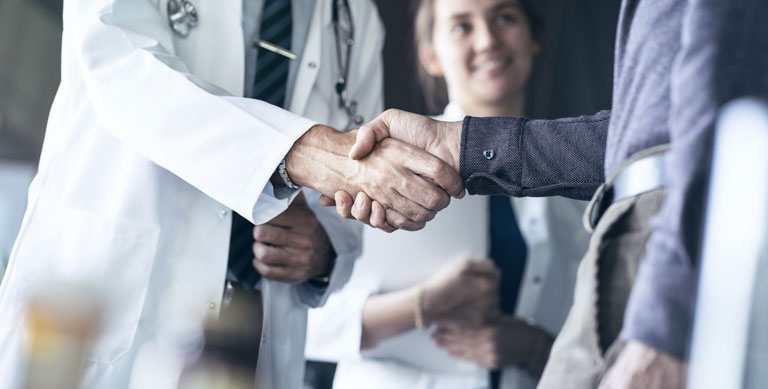 Doctor shaking hands with patient
