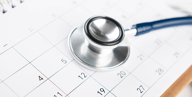 Stethoscope sitting on top of calendar